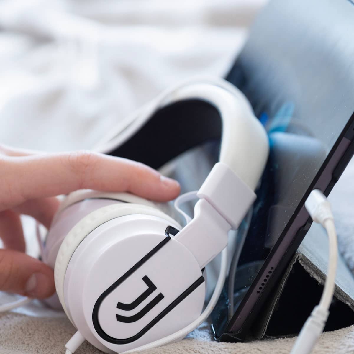Retro tech revival featuring wired headphones connected to a modern mobile device in 2026